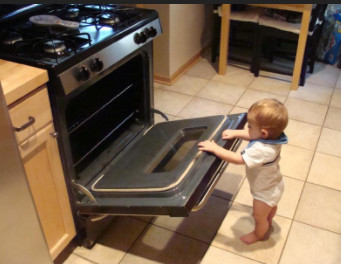 child next to range oven